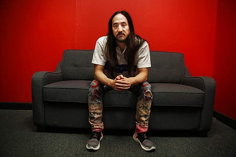 Steve Aoki sits for a portrait during a comic book signing of his new comic book series 'Neon Future' at Multiverse Corps. Comics on Thursday, May 2, 2019, in Miami. (AP Photo/Brynn Anderson)