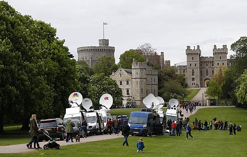 Members of the media gather outside Windsor Castle in Windsor, South England, Monday May 6, 2019, after Prince Harry announced that his wife Meghan has given birth to a boy. (AP Photo/Alastair Grant)