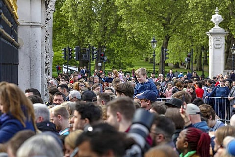 Well-wishers gather outside the gates of Buckingham Palace in London, Monday May 6, 2019, after Prince Harry announced that his wife Meghan has given birth to a boy. (AP Photo/Vudi Xhymshiti)