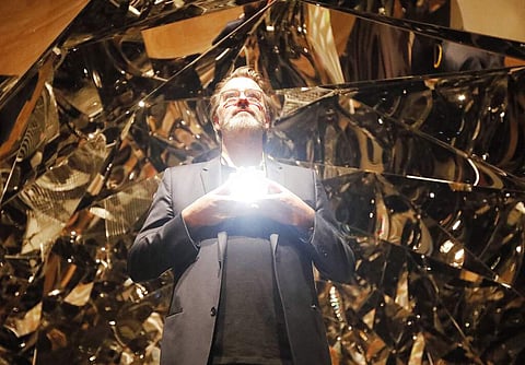 Olafur Eliasson poses at the installation Your Spiral View as part of the exhibition Olafur Eliasson: In Real Life at the Tate Modern Gallery in London. (AP Photo/Frank Augstein)