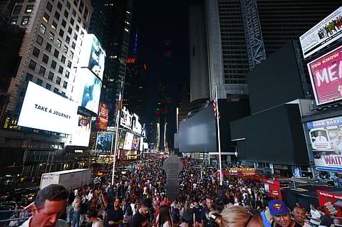 Times Square's towering electronic screens and marquees were blacked out during a power outage in Manhattan, New York leaving many businesses in the theatre district crippled. (AP Photo/Michael Owens)