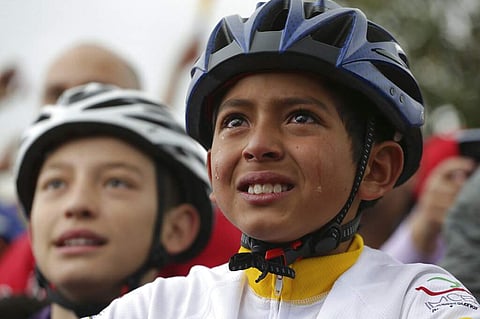 Tears run down the face of a boy watching Colombia's Egan Bernal win the Tour de France cycling race. (AP Photo/Ivan Valencia)(AP Photo/Ivan Valencia)