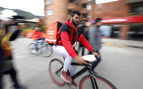 Photo essay: Venezuelan migrants propel billion-dollar delivery app Rappi in traffic-clogged Colombia