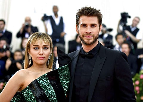 Miley Cyrus and Liam Hemsworth (Photo by Charles Sykes/Invision/AP)