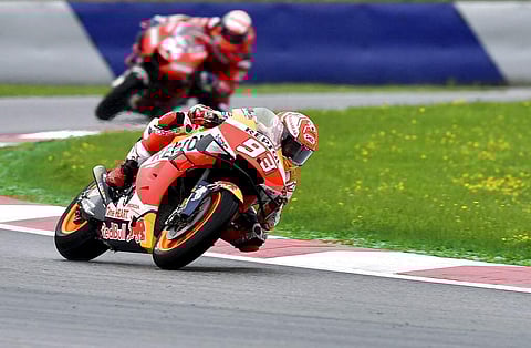 Spain's Marc Marquez of Repsol Honda followed by Italian Andrea Dovizioso of Ducati during a warm up session at the Austrian motorcycle Grand Prix in Spielberg, Austria. (AP Photo/Kerstin Joensson)