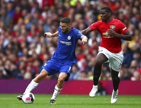 Man U's Paul Pogba challenges Chelsea's Mateo Kovacic. Manchester United beat Chelsea 4-0 to ruin Frank Lampard's debut as a Premier League coach in their season-opening game. (AP Photo/Dave Thompson)