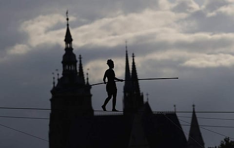 French tightrope walker Tatiana-Mosio Bongoga balances over the Vltava river to open a new circus in Prague, Czech Republic. The Prague Castle is in the background. (AP Photo/Petr David Josek)