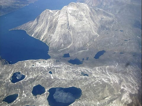 An aerial view of the edge of an ice cap in Nunatarssuk, Greenland. Milder weather than normal since the start of summer has led to concerns of increased melting of ice. (AP Photo/Sandy Virgo)