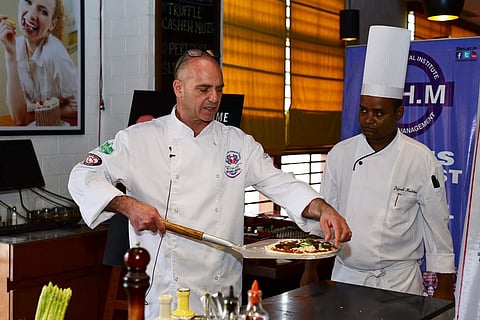 Chef Oliveri making a pizza at Mezzuna