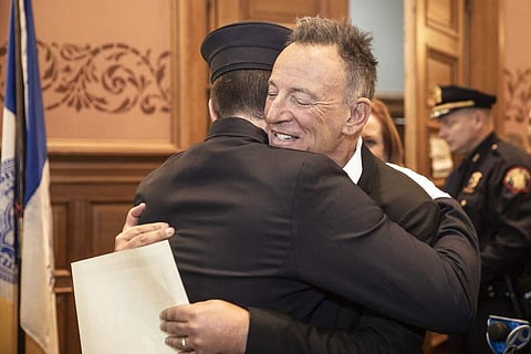 Bruce Springsteen hugs his son Sam (Jennifer Brown/Jersey City Mayor's Office via AP)