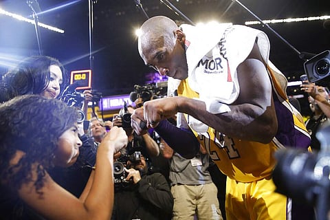April 13, 2016: Kobe Bryant fist-bumps his daughter Gianna (AP Photo/Jae C. Hong, File)