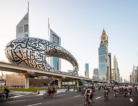Riders pass by Museum of The Future, one of the finest example of modern art in Dubai