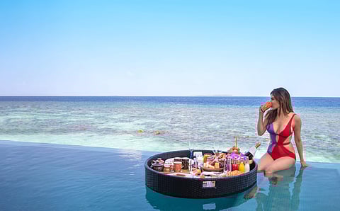 Mouny Roy enjoying floating breakfast and the sea views at Heritance Aarah in The Maldives