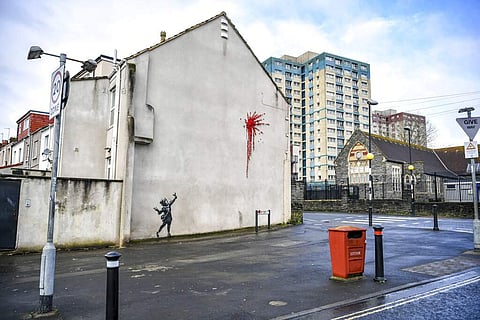 Banksy's work at a Bristol home (Ben Birchall/PA via AP)