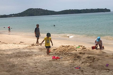 Visitors swim on a beach in Phuket, Thailand, in the last week of March 2020, even as tourists across Asia find their dream vacations have turned into travel nightmares. (AP Photo/Penny Wang)