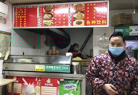 Stores owners sel the local favorite 'reganmian' or 'hot dry noodles' (AP Photo/Olivia Zhang)