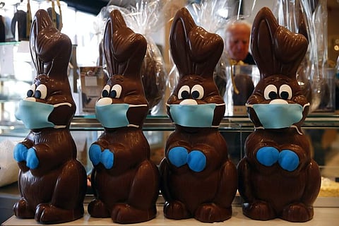 Chocolate Easter bunnies with masks are on display at a cake shop in Lykovrisi, northern Athens, Greece. (AP Photo/Thanassis Stavrakis)