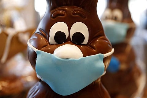 A chocolate Easter bunny with mask is on display at a cake shop in Lykovrisi, northern Athens, Greece. (AP Photo/Thanassis Stavrakis)