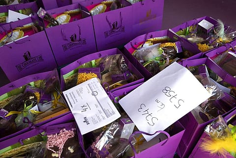 Order slips are placed on top of bags of chocolate waiting to be picked up at the Chocolate Line warehouse in Bruges, Belgium. (AP Photo/Virginia Mayo)