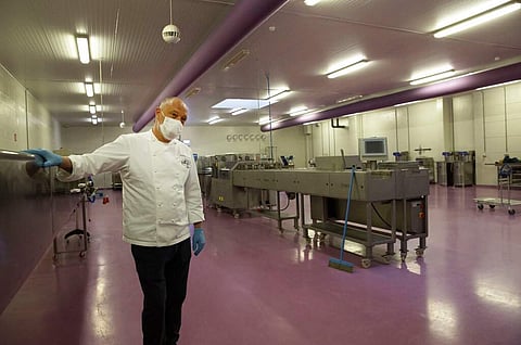 One of Belgium's top chocolate producers Dominique Persoone stands in one of his production rooms with no workers, at his Chocolate Line warehouse in Bruges, Belgium. (AP Photo/Virginia Mayo)
