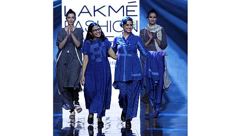 Jayati Goenka flanked by models wearing her collection.