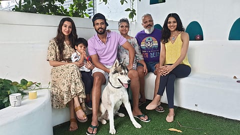 Aadarsh Balakrishna flanked by his family and pet.