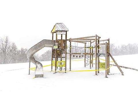 A playground covered in snow is closed at Normafa during during the coronavirus in Budapest, Hungary. (Marton Monus/MTI via AP)