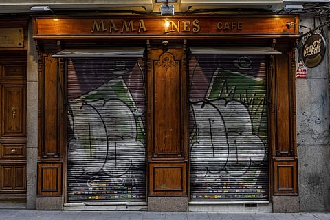 The entrance of a cafe closed during the coronavirus outbreak in Madrid, Spain. (AP Photo/Bernat Armangue)