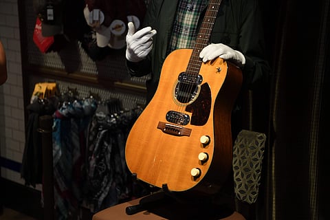 Co-owner of Julien's Auctions Martin Nolan displays Kurt Cobain's guitar at the Hard Rock Cafe Piccadilly Circus in central London. (Pic: AFP/DANIEL LEAL-OLIVAS)