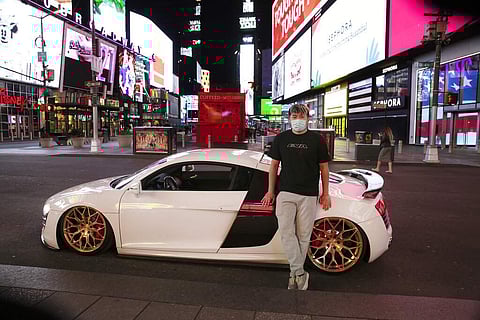 Danny Lin with his 2008 Audi R8 at Times Square (AP Photo/Mark Lennihan)