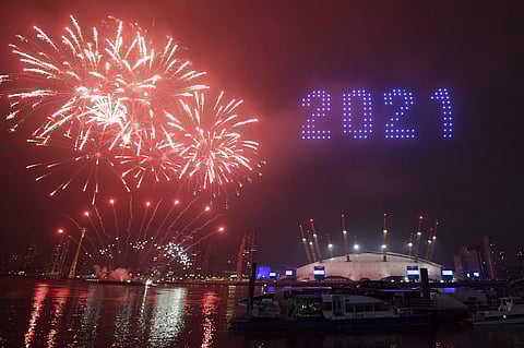 Fireworks and drones illuminate the night sky over London