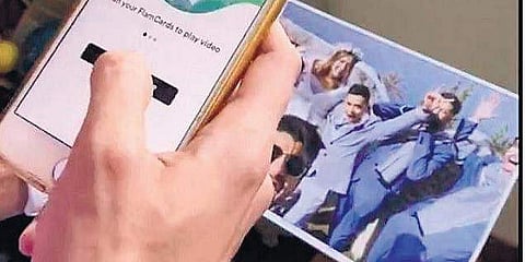 Just like you scan a QR code and it takes you to a website where you can order food in a restaurant, the app allows you to watch a video with a photograph