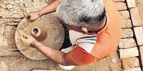 A potter crafting a terracotta vase