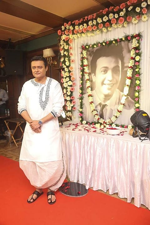 Saswata Chatterjee poses in front of Uttam Kumar's portrait during the mahurat of Achena Uttam
