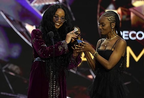 H.E.R., left, and Tiara Thomas accept the award for song of the year for 'I Can't Breathe'at the 63rd annual Grammy Awards at the Los Angeles Convention Center