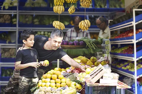 Indian father buying vegetables with his son Pic: Avinash Gowariker)