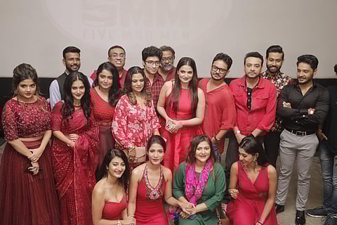 The cast of the multi-starrer film Mayaa, dressed in red, at the logo launch