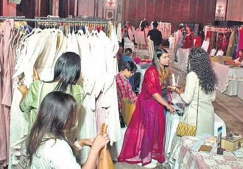 Attendees browsing through various stalls at the Design Show