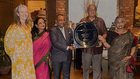 Officials of Lalit Great Eastern receive the memento by INTACH