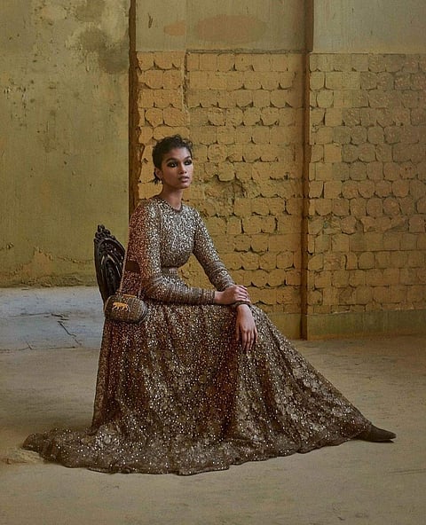 A hand dyed tulle portrait gown embroidered with bevel beads, hand cut sequins, trimmed with hand dyed wool.