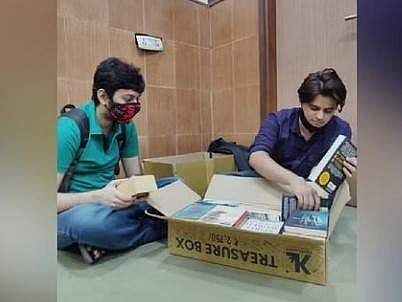 Visitors load their books in the box.