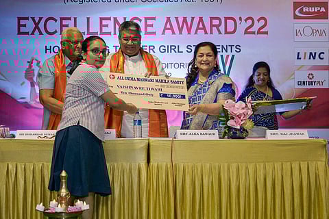 Alka Bangur, Bishambar Newar and Dinesh Bajaj felicitating a student
