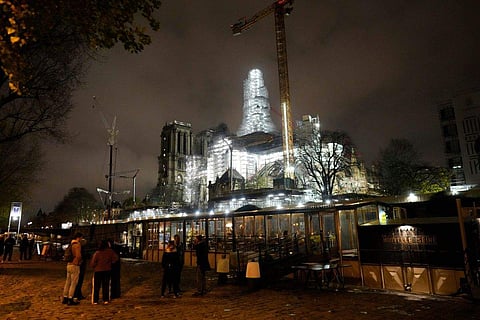 Notre-Dame de Paris cathedral is seen with its spire surrounded by scaffolding