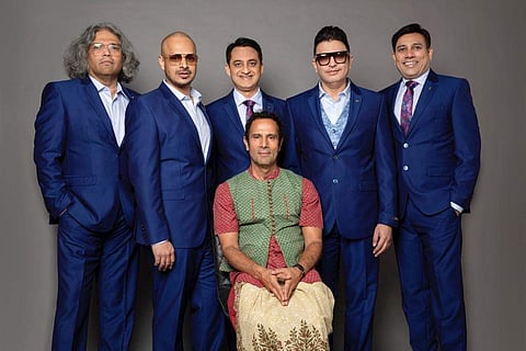 Tarsem Singh (centre, sitting) with his team