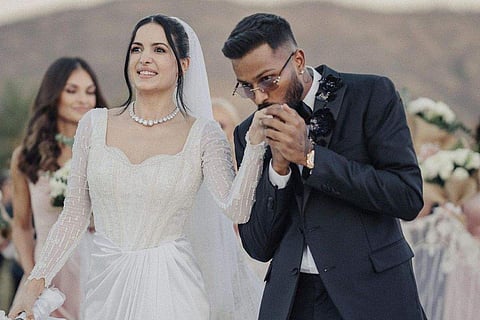 Natasa was a conventional Christian bride, wearing a white gown, and a pearl necklace