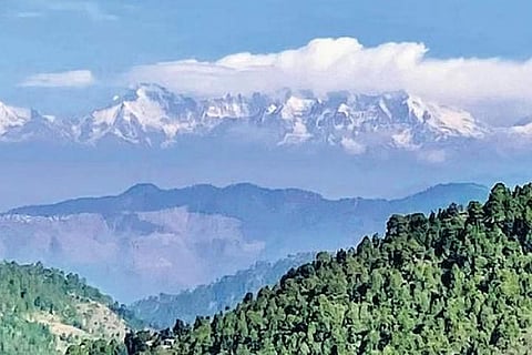 The Shivalik peaks shakes off its mist blanket and shows itself in ice-capped glory