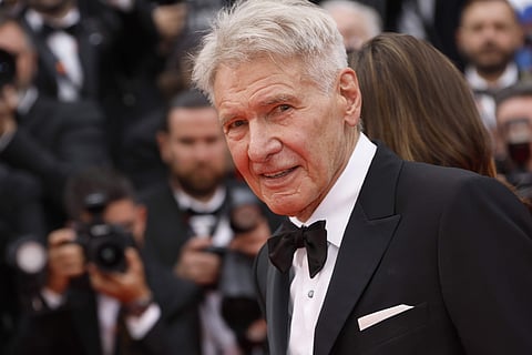 Harrison Ford poses for photographers upon arrival at the premiere of the film Indiana Jones and the Dial of Destiny