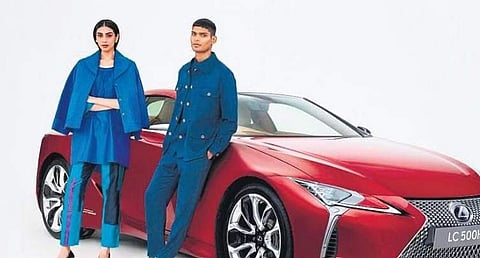 Models in limited-edition jackets in front of the new Lexus LC 500h