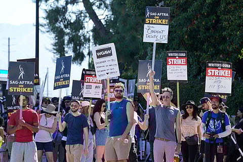 Actors and writers demonstrate on a picket line outside Disney studios on July 18