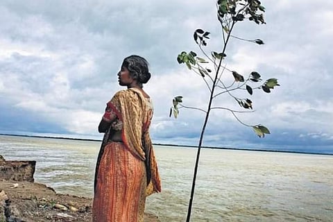 Puspa Rani Roy at the edge of her land.